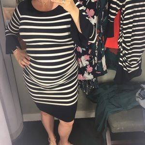 A pea in the pod dress. Fitted with ruched sides and bell sleeve detailing